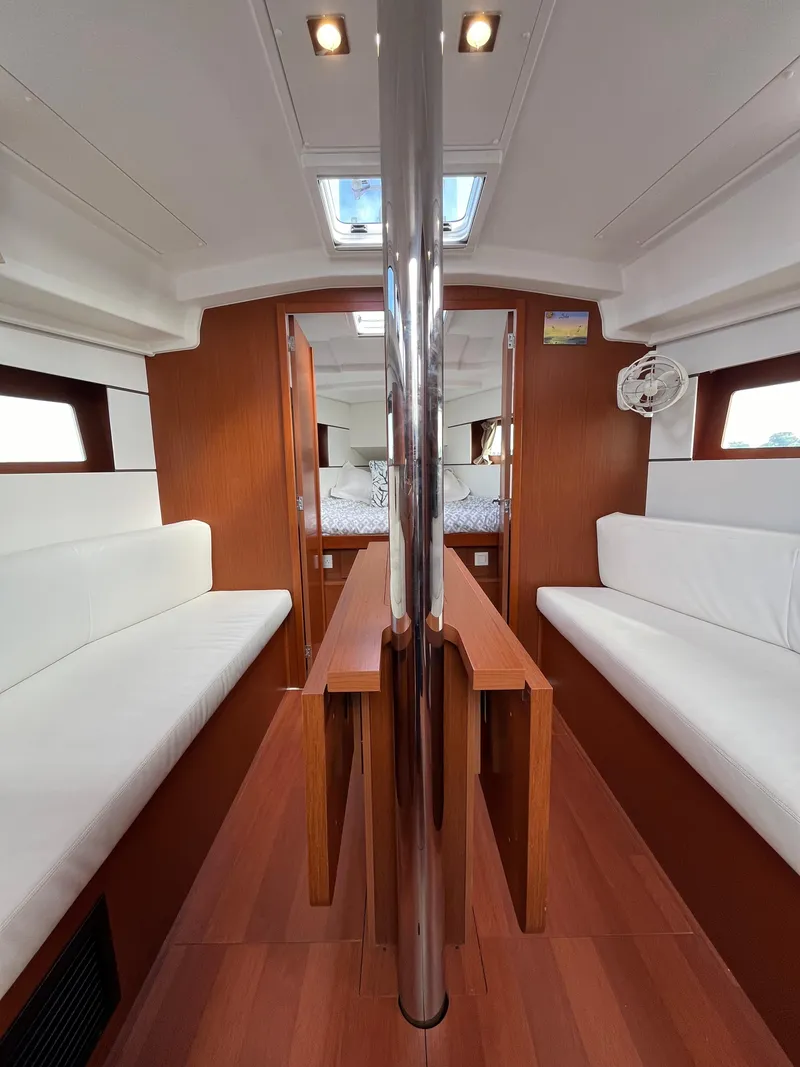 Slide: The Image of Interior of 2018 Beneteau Oceanis 35.1 sailboat with wood finish and white seating. - 45