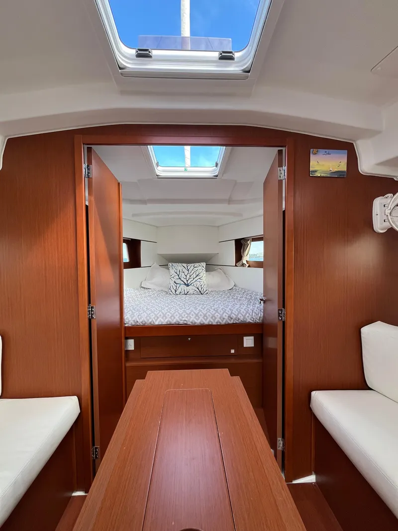 Slide: The Image of Interior of 2018 Beneteau Oceanis 35.1 sailboat, featuring cozy cabin and skylight. - 48