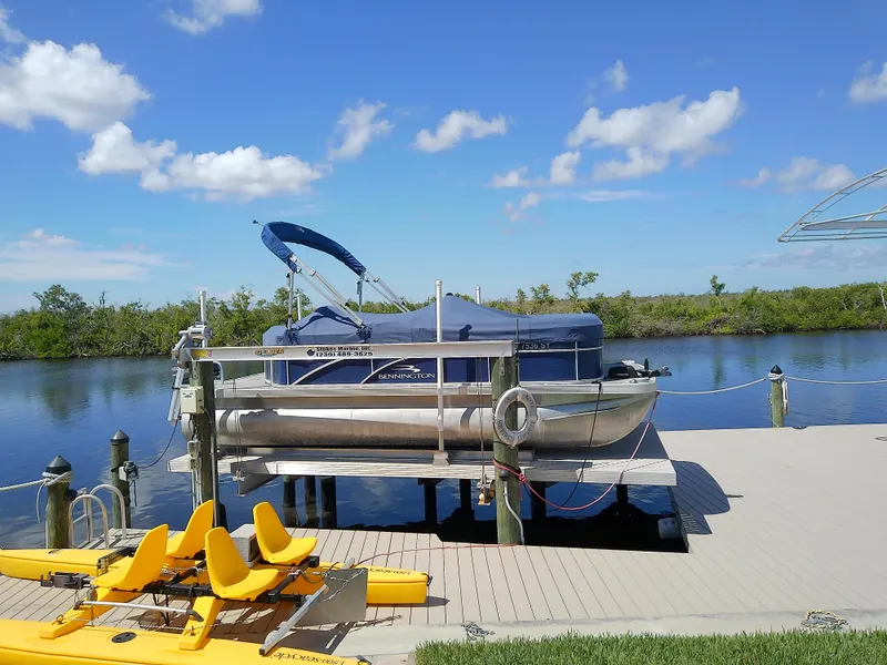 Slide: The Image of 2020 Bennington SV 20 SLV pontoon boat docked on a sunny day. - 0