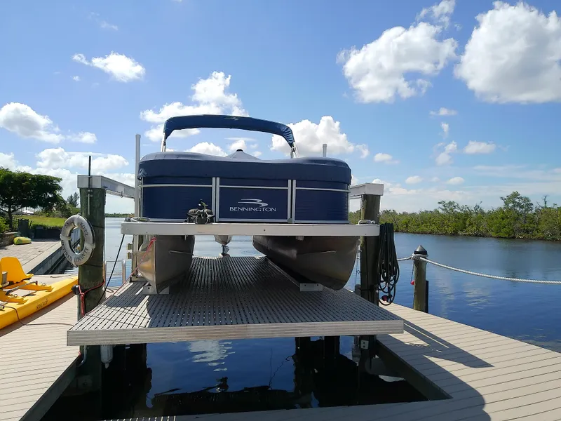 Slide: The Image of 2020 Bennington SV 20 SLV pontoon boat on dock under blue sky. - 2