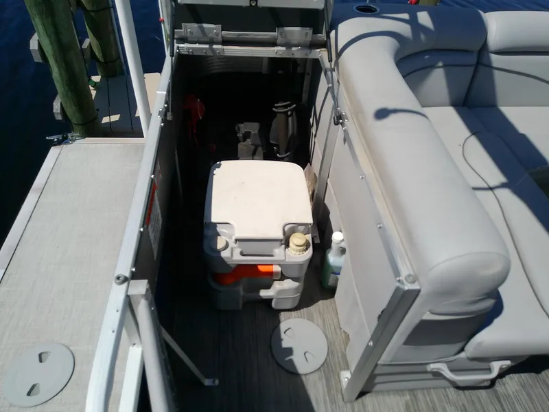 Slide: The Image of 2020 Bennington SV 20 SLV boat storage area with cooler and seating. - 27