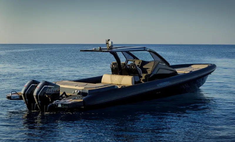 Slide: The Image of 2025 Technohull Alpha 40 boat on calm sea, featuring sleek design and powerful engines. - 13