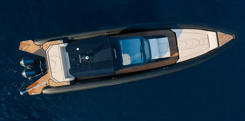Slide: The Image of 2025 Technohull Alpha 40 luxury boat, aerial view, sleek design on blue water. - 2
