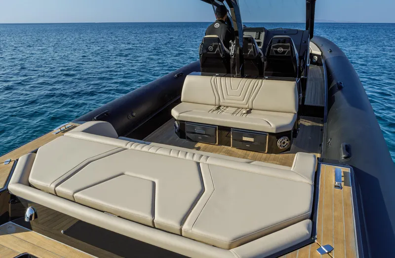 Slide: The Image of 2025 Technohull Alpha 40 luxury boat interior with beige seating on open water. - 21