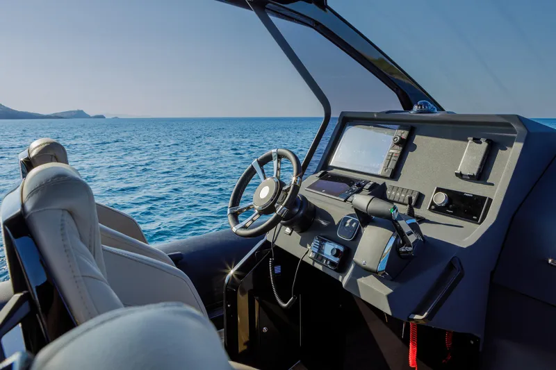 Slide: The Image of Cockpit of 2025 Technohull Alpha 40 boat with modern controls, overlooking the sea. - 24