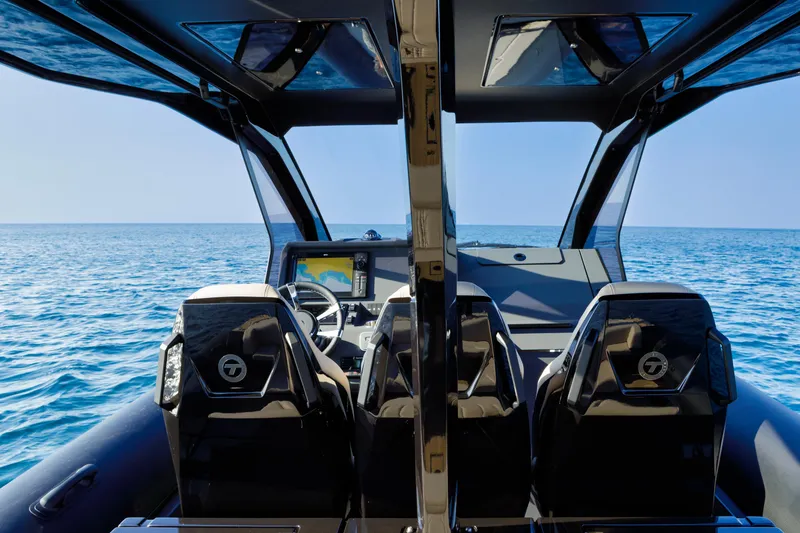 Slide: The Image of Technohull Alpha 40 cockpit view, 2025 model, overlooking the ocean. - 25