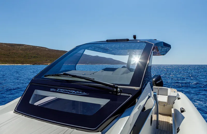 Slide: The Image of 2025 Technohull Alpha 40 boat on clear blue water, sleek design, sunny day. - 10