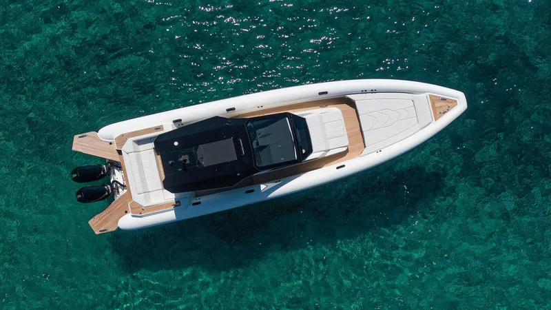 Slide: The Image of Technohull Alpha 40 (2025) luxury boat on clear turquoise water, aerial view. - 2