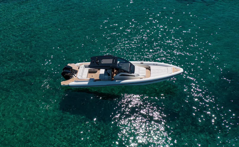 Slide: The Image of Technohull Alpha 40 (2025) cruising on clear turquoise water, aerial view. - 3