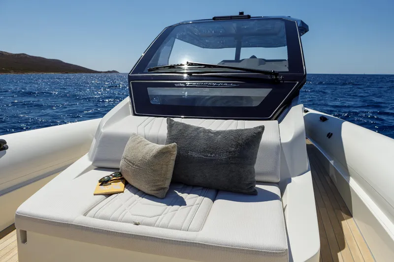 Slide: The Image of 2025 Technohull Alpha 40 luxury boat with sunbed and cushions on open sea. - 11