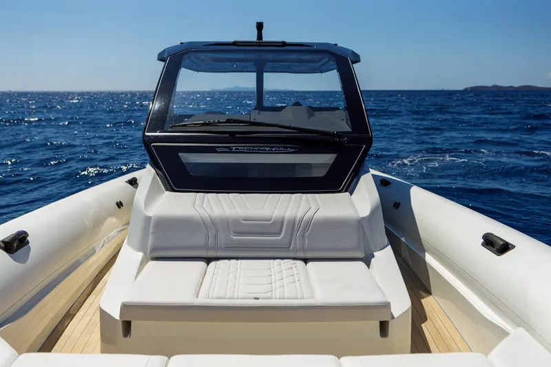 Slide: The Image of 2025 Technohull Alpha 40 boat on open sea, featuring sleek design and spacious seating. - 12