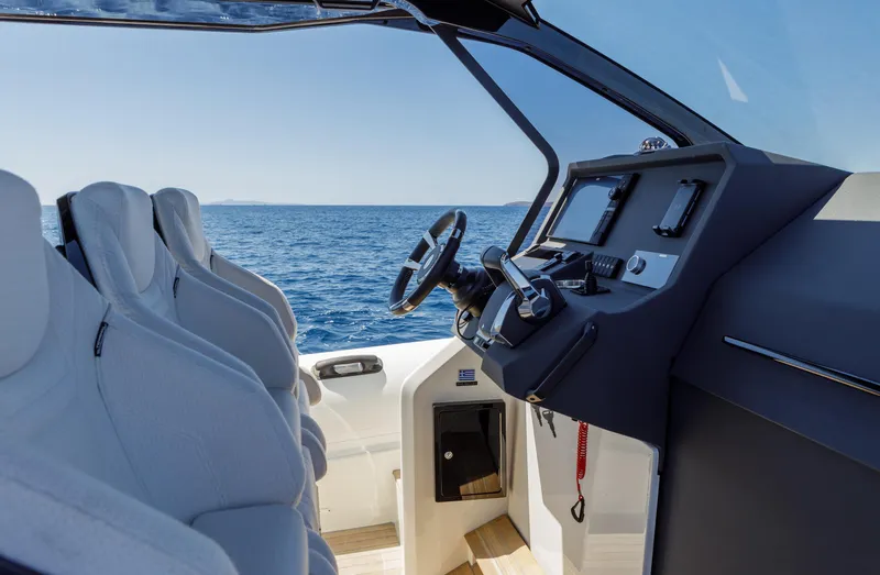 Slide: The Image of Interior of 2025 Technohull Alpha 40 boat with modern dashboard and ocean view. - 7