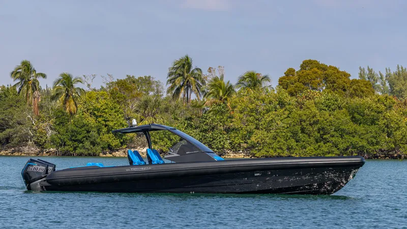 Slide: The Image of 2025 Technohull 38 Grand Sport boat on water, surrounded by lush greenery. - 10