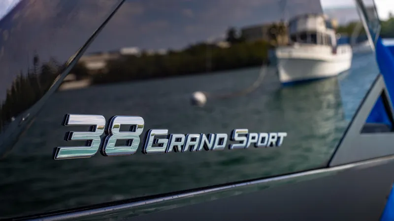 Slide: The Image of 2025 Technohull 38 Grand Sport logo on sleek boat exterior. - 20