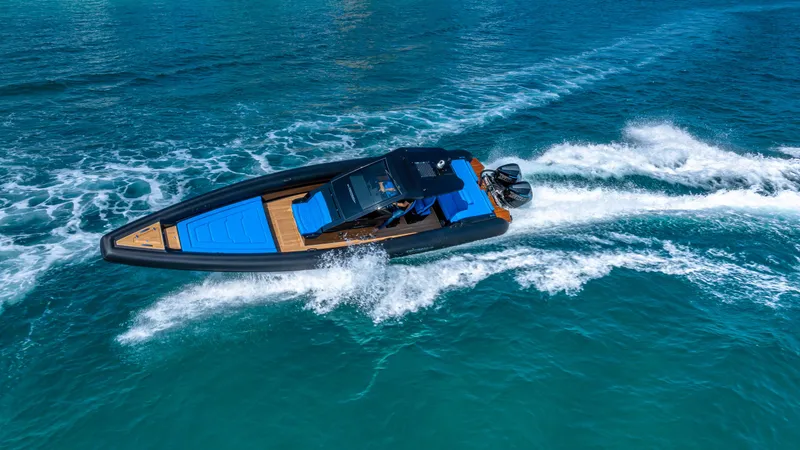 Slide: The Image of 2025 Technohull 38 Grand Sport speeding on clear blue water. - 30