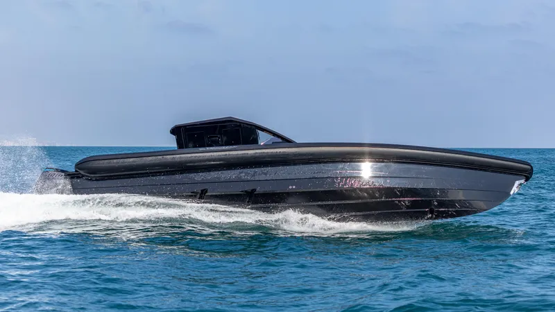 Slide: The Image of 2025 Technohull 38 Grand Sport speeding on open water. - 5