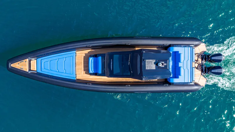 Slide: The Image of 2025 Technohull 38 Grand Sport boat on clear blue water, aerial view. - 6