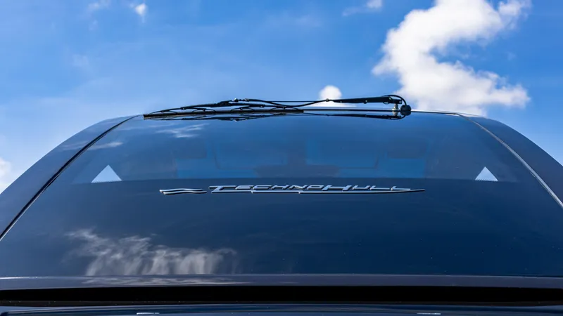 Slide: The Image of 2025 Technohull 38 Grand Sport boat windshield against blue sky. - 18