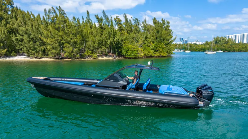 Slide: The Image of 2025 Technohull 38 Grand Sport boat cruising on a scenic waterway. - 21