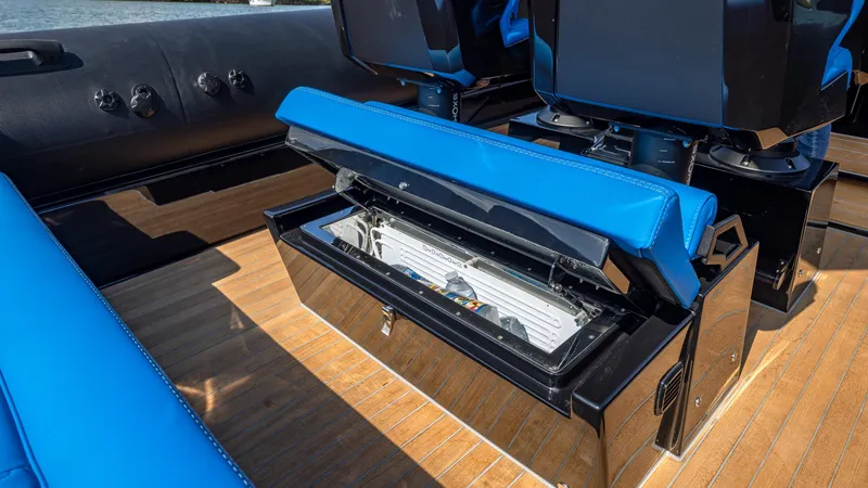 Slide: The Image of 2025 Technohull 38 Grand Sport boat with open storage compartment and blue seating. - 28