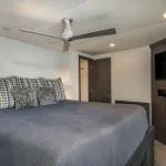 Slide: The Image of Modern bedroom with ceiling fan and blue bedding, Adonia Allure Trip 2020. - 4