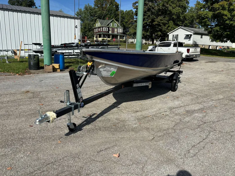 Slide: The Image of 2025 Crestliner 1672 Outlook boat on trailer in outdoor setting. - 2