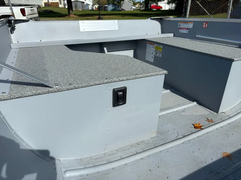 Slide: The Image of 2025 Crestliner 1672 Outlook boat interior with storage compartments and seating. - 6