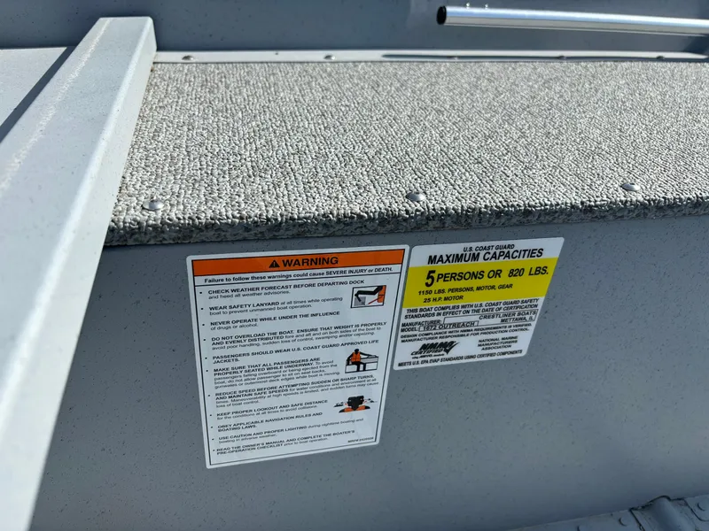 Slide: The Image of 2025 Crestliner 1672 Outlook boat capacity and warning labels, seating area detail. - 8