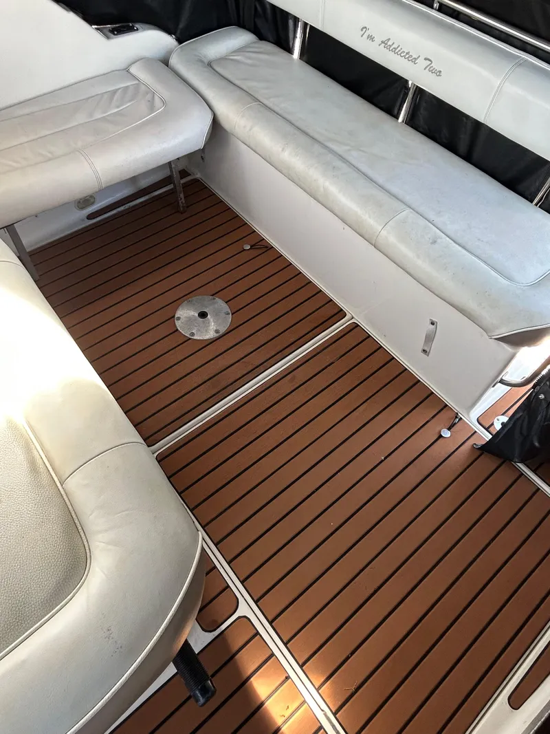 Slide: The Image of 1993 Maxum 2700 SCR boat interior with teak flooring and white seating. - 4