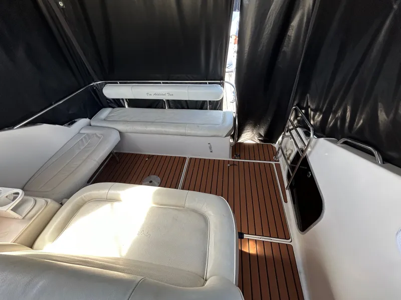 Slide: The Image of 1993 Maxum 2700 SCR boat interior with cushioned seating and wood flooring. - 6