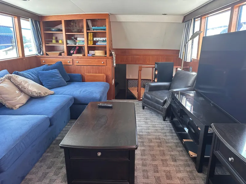 Slide: The Image of Luxurious 1965 Burger Flush Deck yacht interior with blue sofa, wooden cabinetry, and modern furnishings. - 8