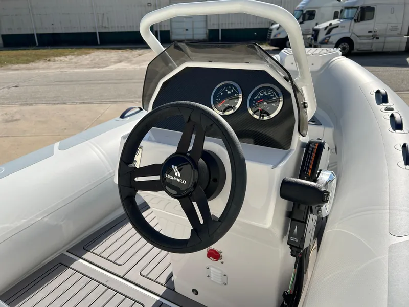 Slide: The Image of 2024 Highfield Classic 420 boat steering console with gauges and controls. - 14