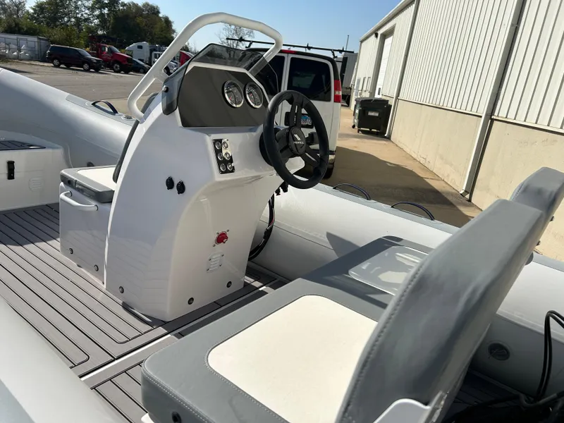 Slide: The Image of 2024 Highfield Classic 420 boat interior with steering console and seating. - 7