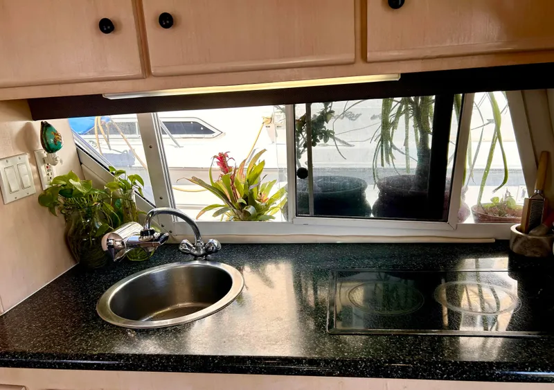 Slide: The Image of Kitchen area of 1999 Carver Voyager 370 with sink, stove, and window view. - 13