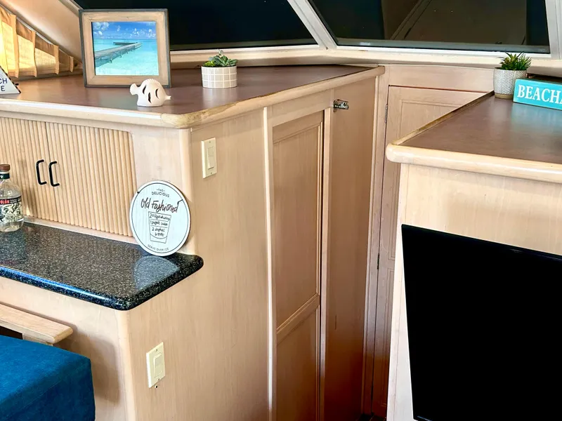 Slide: The Image of Interior of 1999 Carver Voyager 370 with wood cabinetry and decorative accents. - 14