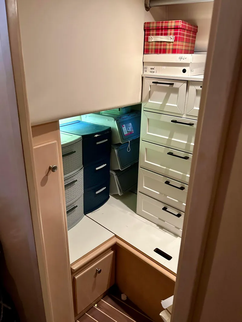 Slide: The Image of Storage area with organized drawers and boxes in a 1999 Carver Voyager 370 boat. - 15