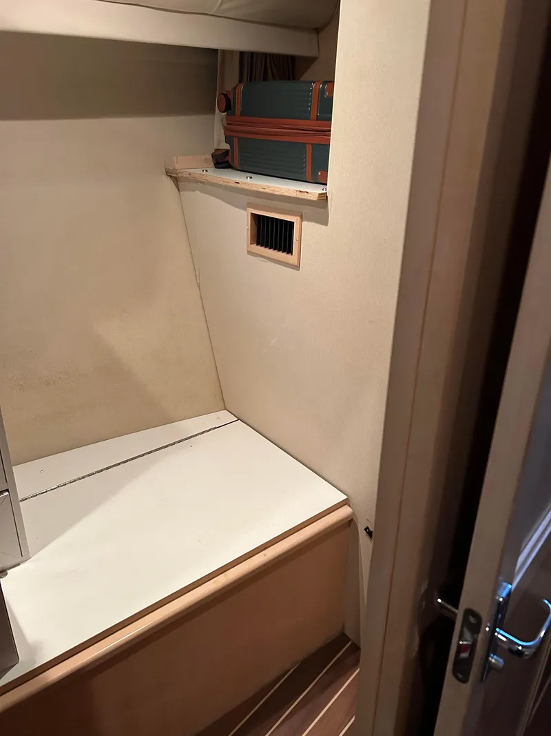 Slide: The Image of 1999 Carver Voyager 370 interior cabin with storage shelf and wooden flooring. - 16