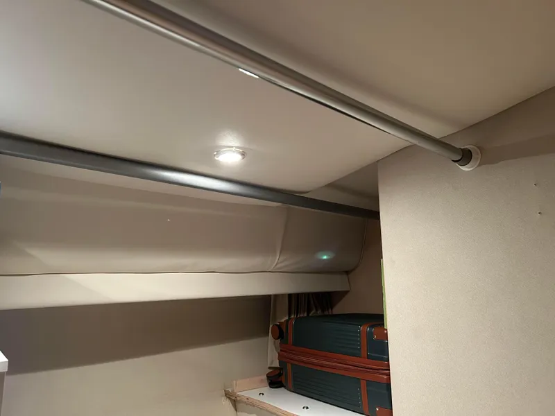 Slide: The Image of Interior storage space of 1999 Carver Voyager 370 boat with luggage. - 17