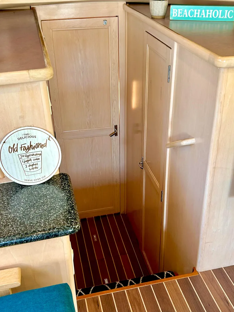 Slide: The Image of Interior of 1999 Carver Voyager 370 yacht with wooden cabinetry and nautical decor. - 18