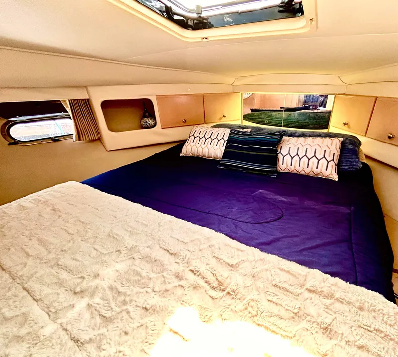 Slide: The Image of Cozy bedroom in 1999 Carver Voyager 370 yacht with plush bedding and natural light. - 19