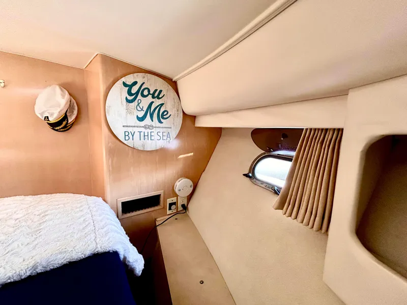 Slide: The Image of Cozy cabin interior of 1999 Carver Voyager 370 with nautical decor and porthole window. - 22