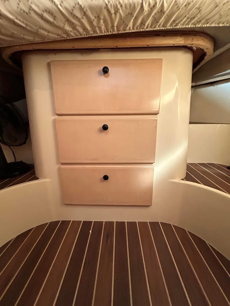 Slide: The Image of 1999 Carver Voyager 370 interior with wooden drawers and striped flooring. - 23