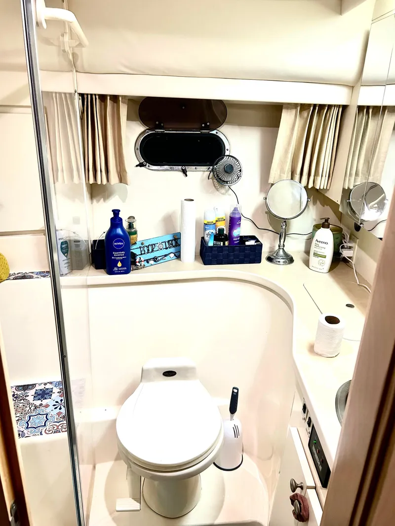 Slide: The Image of 1999 Carver Voyager 370 bathroom with toiletries and mirror. - 24