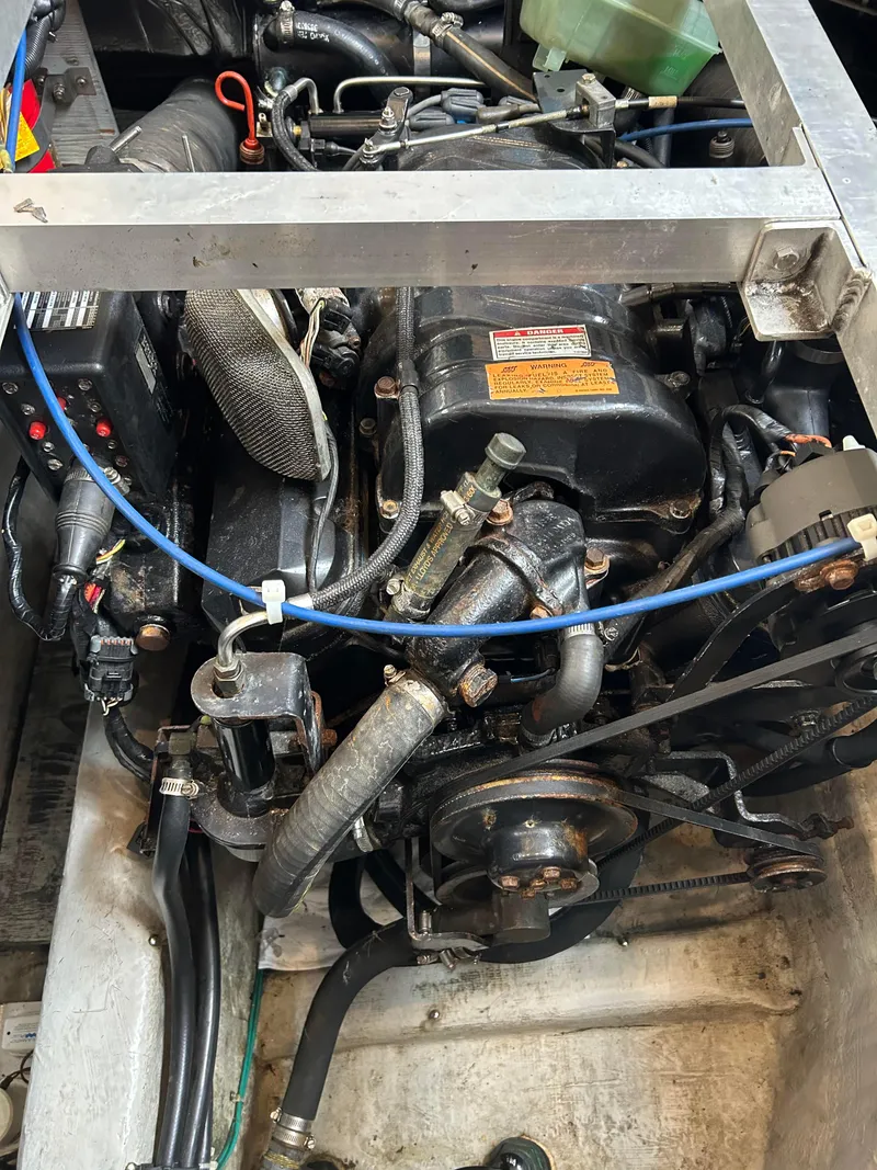 Slide: The Image of Engine compartment of a 1999 Carver Voyager 370 boat, showcasing mechanical components. - 27