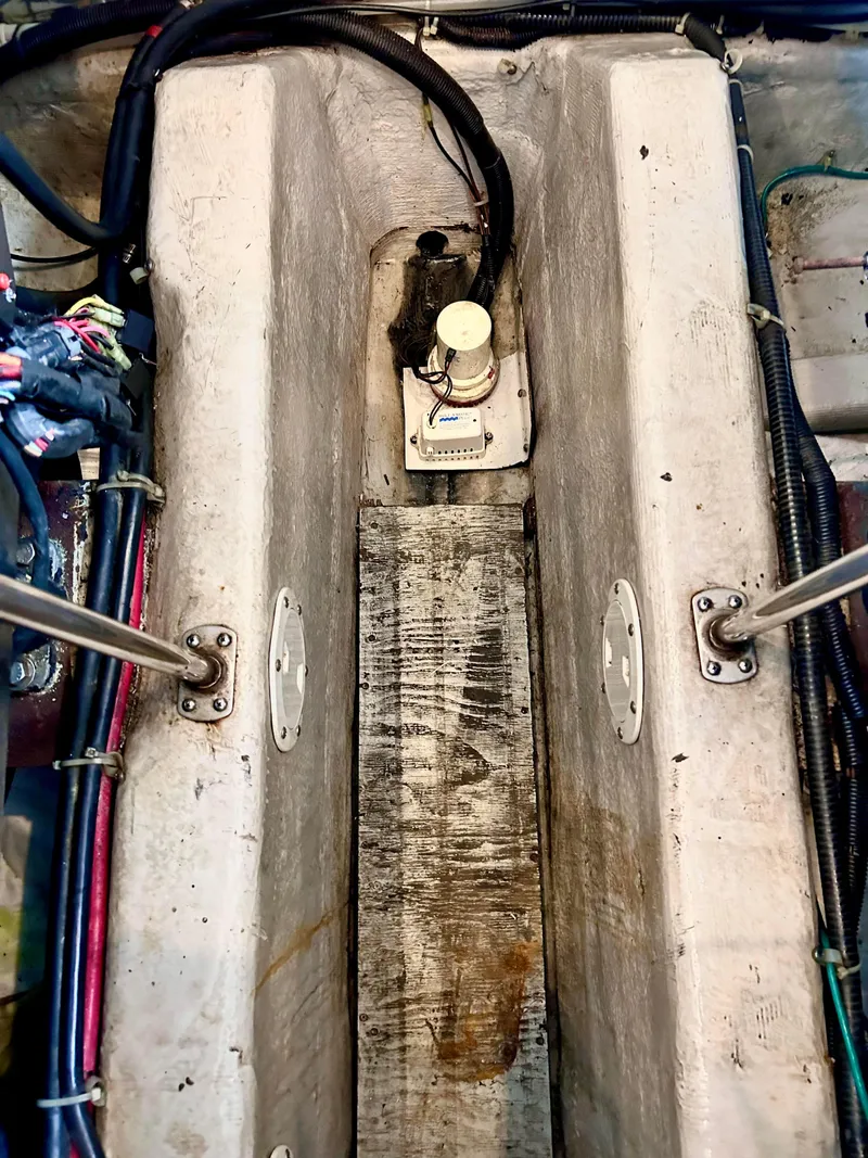 Slide: The Image of Engine compartment of 1999 Carver Voyager 370 with visible wiring and components. - 30