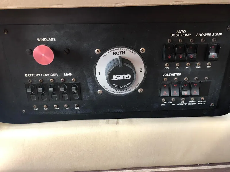 Slide: The Image of Control panel of a 1999 Carver Voyager 370 boat with various switches and gauges. - 34