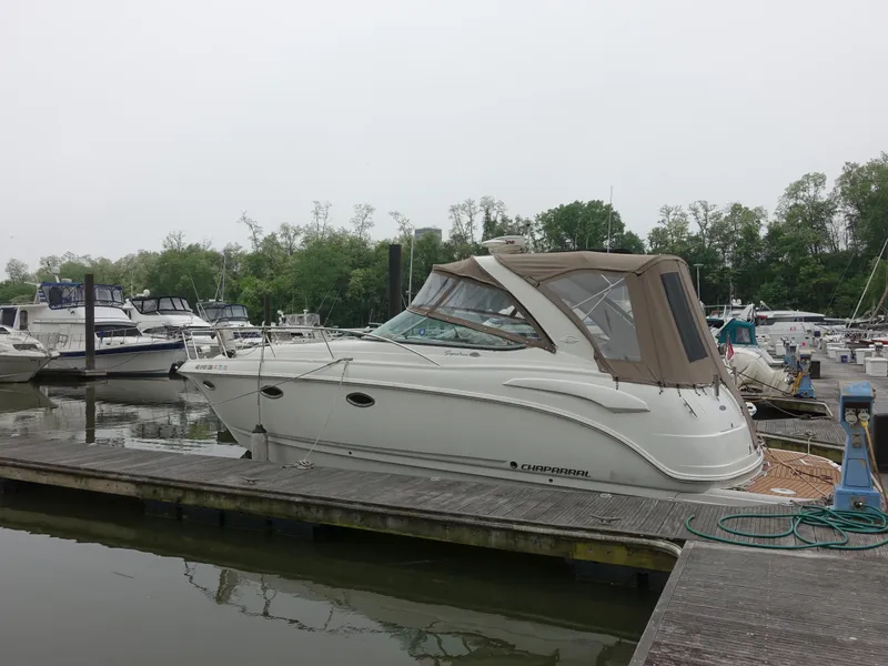 The Image of 2008 Chaparral Signature 330 boat docked at a marina, surrounded by other vessels. - 0