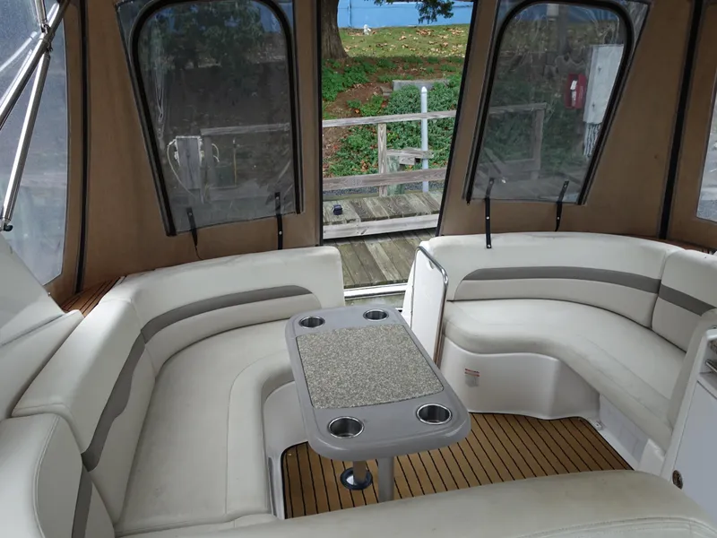 Slide: The Image of 2008 Chaparral Signature 330 boat interior with cushioned seating and table. - 11