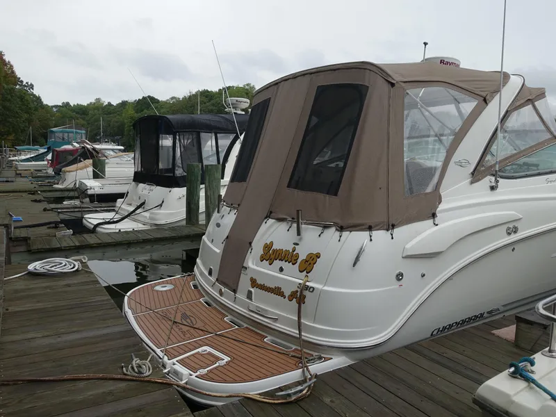 Slide: The Image of 2008 Chaparral Signature 330 boat docked at a marina with other vessels. - 26