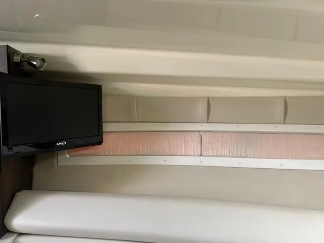 Slide: The Image of Interior of 2017 Monterey 295 Sport Yacht with mounted TV and cushioned seating. - 10